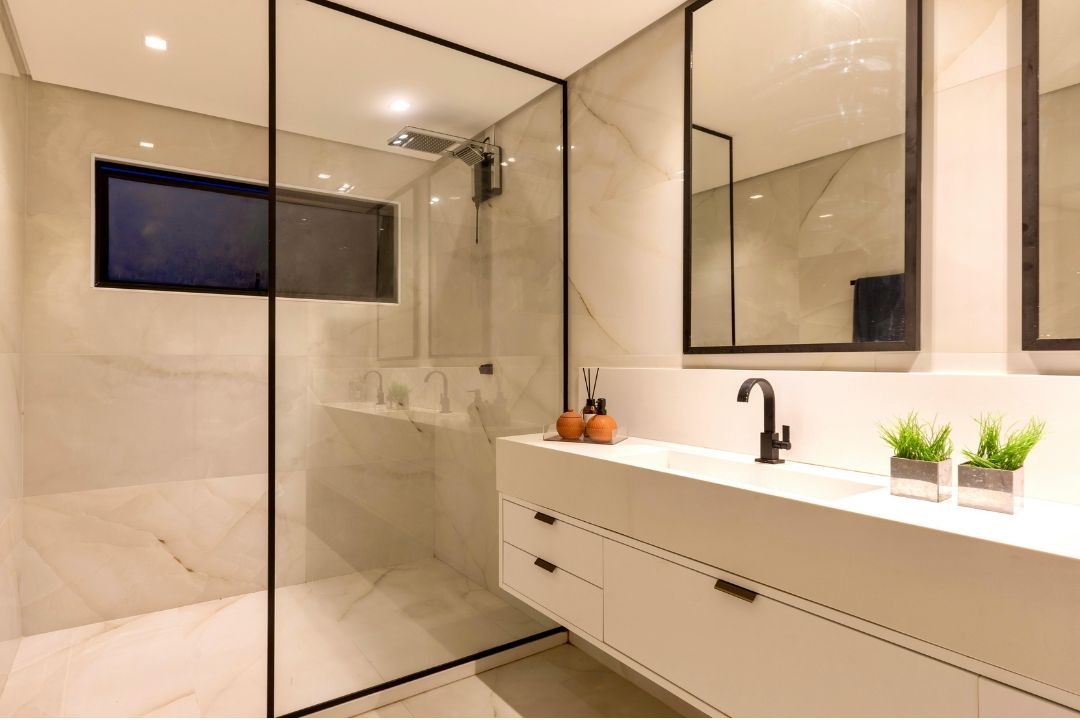Newly built bathroom with glass shower, fully cleaned