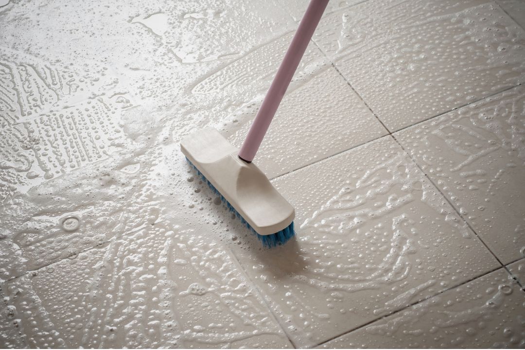 Floor machine polishing a commercial tile floor