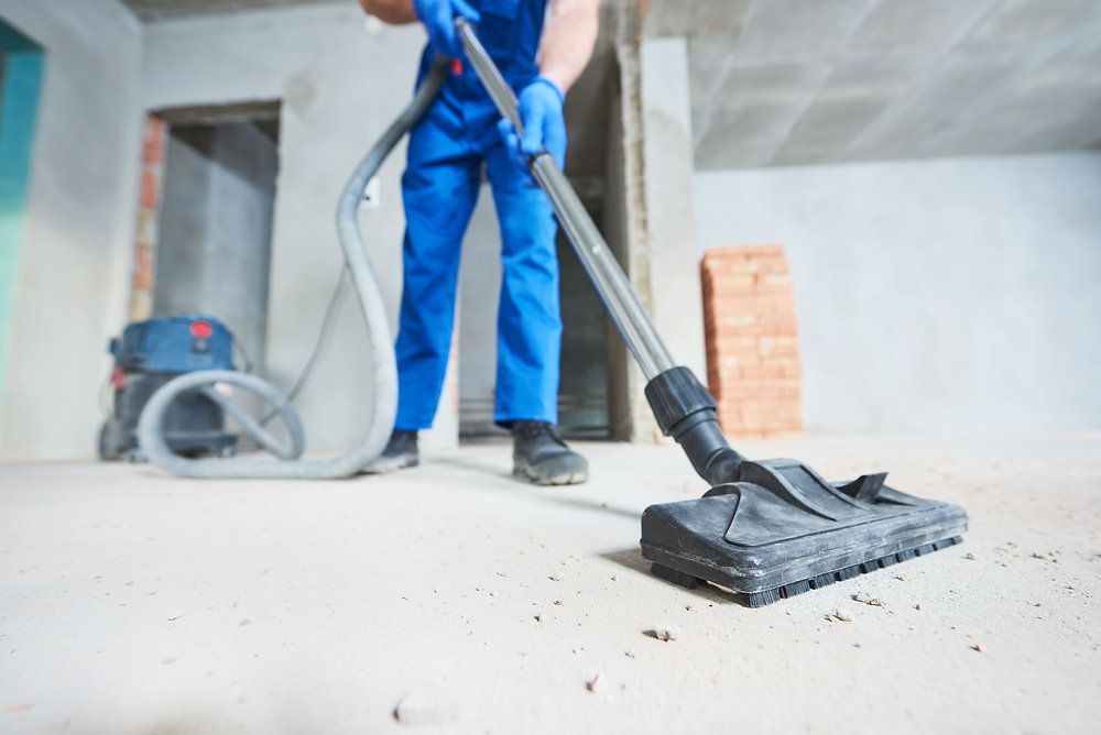 Vacuuming construction dust from a concrete floor