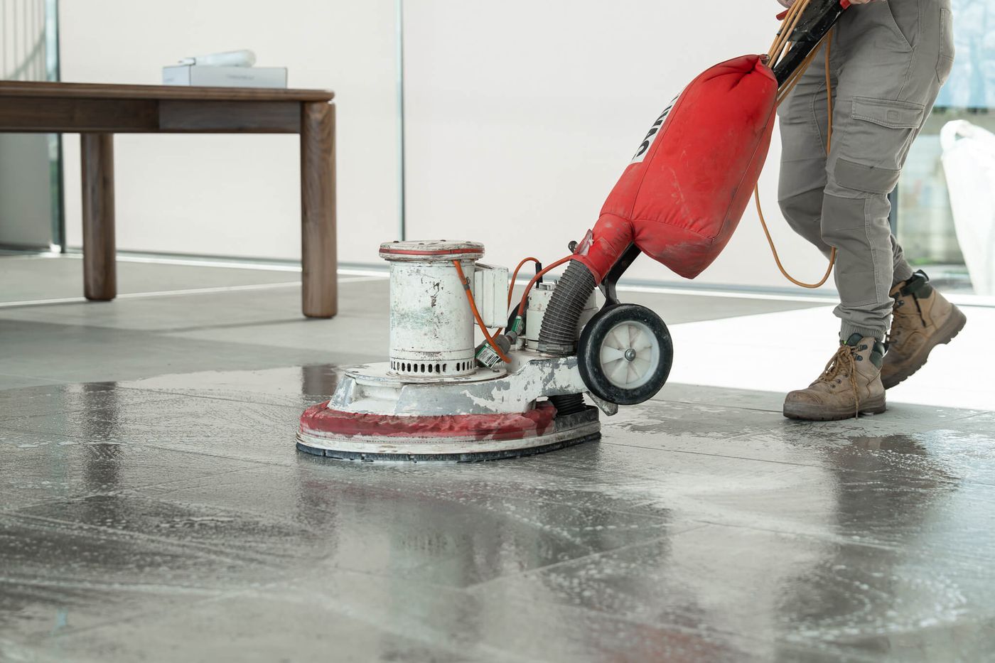 Floor machine cleaning a newly finished tile floor after construction