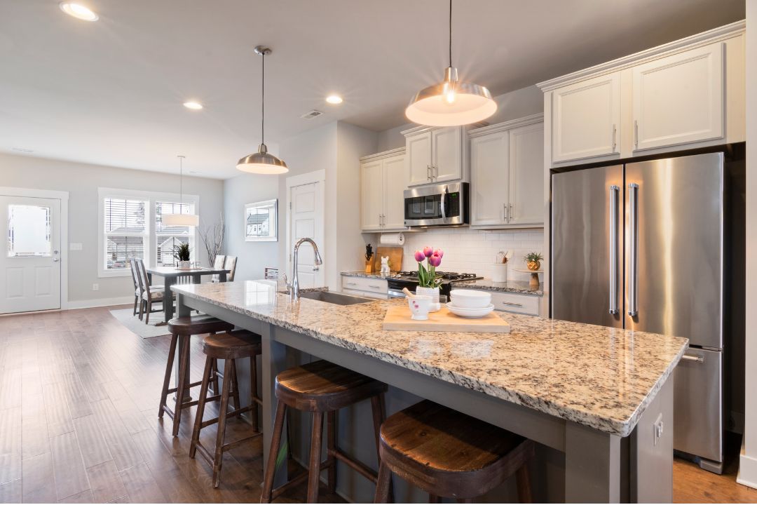 Bright, clean kitchen with a granite island after a standard cleaning